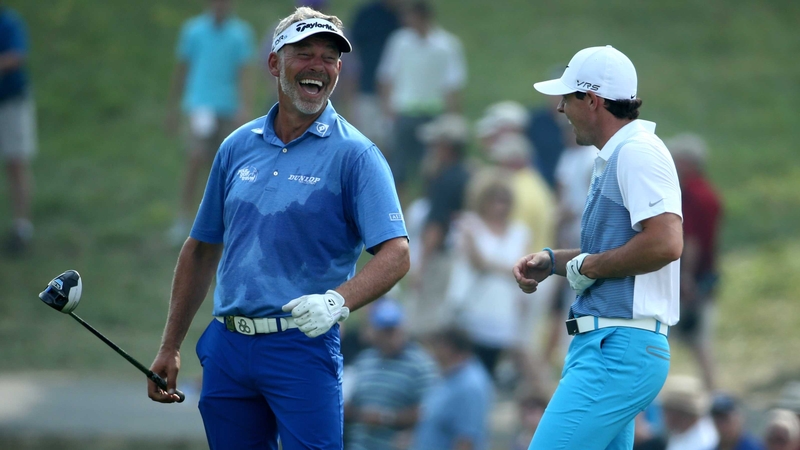 Darren Clarke and Rory McIlroy share a joke at the PGA Championship in August