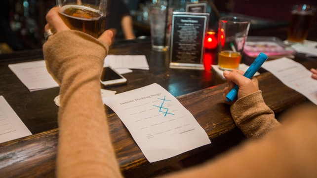 Potential voters play a version of bingo as they watch the debate at a bar in Philadelphia, Pennsylvania