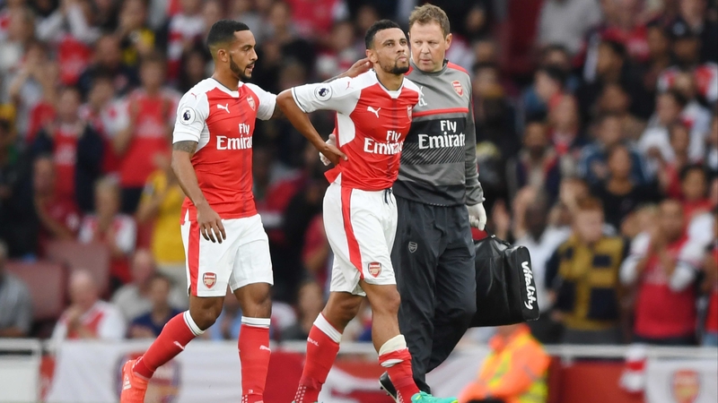 Francis Coquelin (C) leaves the field injured at the weekend