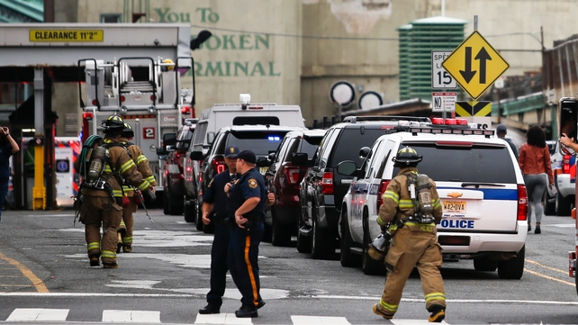New Jersey police officers and firefighters arrive at the train terminal