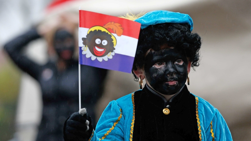 A child dressed as 'Zwarte Piet' walks in Gouda, The Netherlands