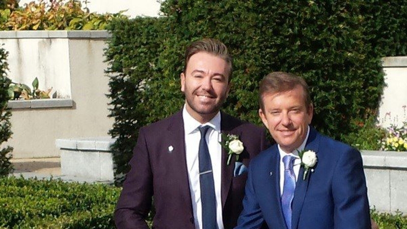 Hughes says he is "happy and proud" to have wed his long-term partner Karl Broderick