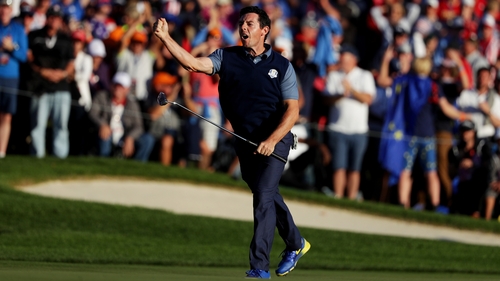 McIlroy celebrates his eagle putt to win his four-ball match