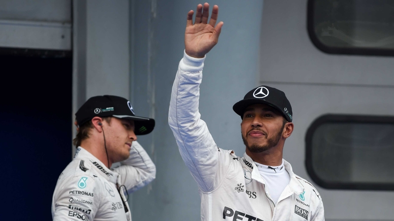 Lewis Hamilton salutes the crowd after claiming pole, with Nico Rosberg in the backround