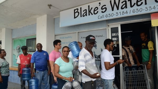 People wait in line to refill water bottles in preparation for Hurricane Matthew in Kingston, Jamaica