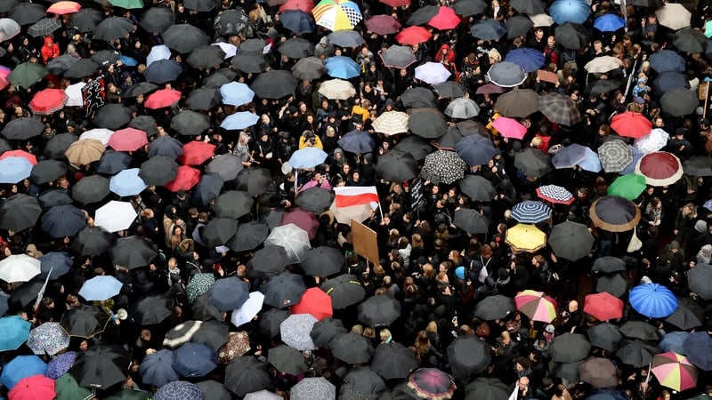 People attend a protest against the proposed law in Warsaw