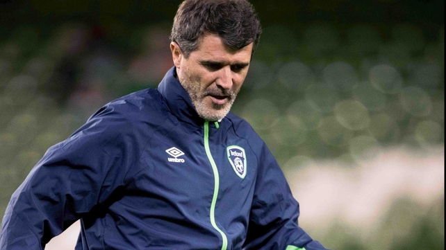 Ireland assistant manager warms up along with the team on the pitch before kick-off