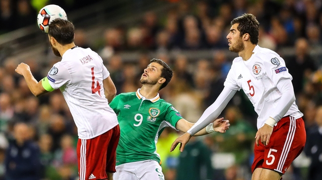 Shane Long tussles with Georgia's Guram Kashia and Solomon Kvirkvelia