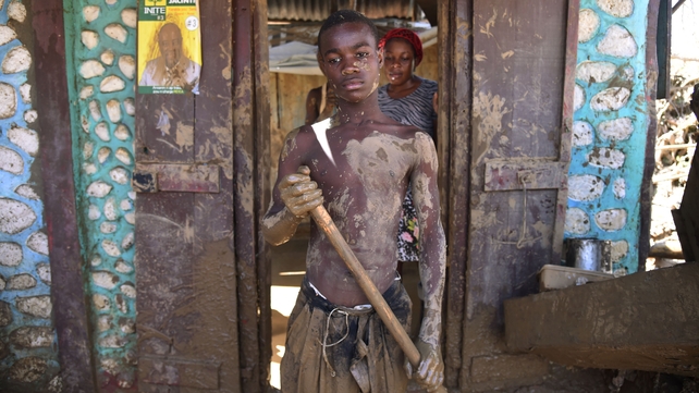 Sadame rests a moment while removing mud of his destroyed house by the Hurricane Matthew, in Jeremie