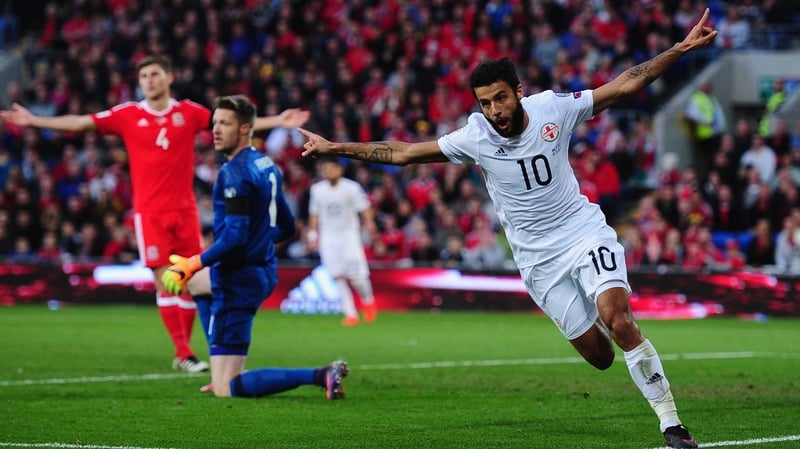 Tomike Okriashvili of Georgia wheels away in celebration after heading home against Wales