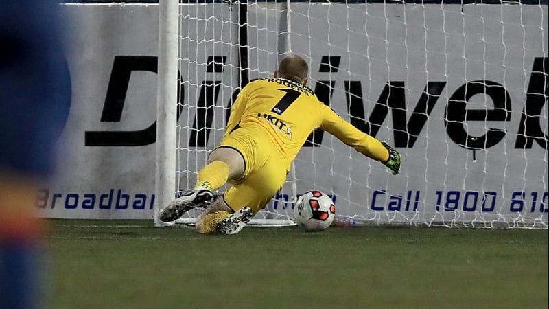 Gary Rogers attempting to sweep up his mistake against Sligo before Achille Campion tapped home