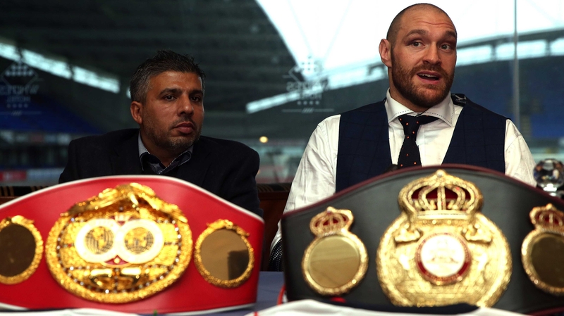 Tyson Fury (R) said: 'I have taken the hard and emotional decision to now officially vacate my treasured world titles.'