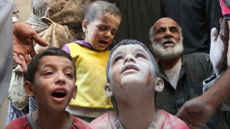 Syrian boys cry following Russian air strikes on the Fardous neighbourhood of the northern embattled Syrian city of Aleppo