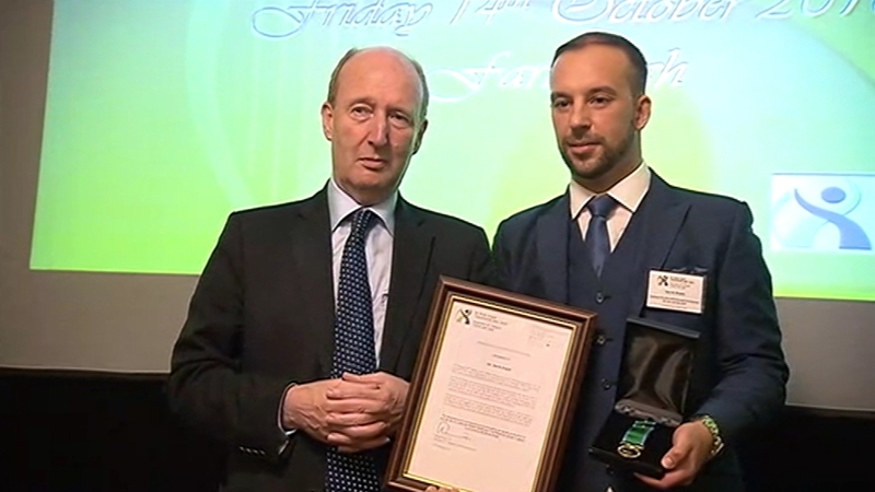 Davitt Walsh (right) was presented with his award by Transport Minister Shane Ross