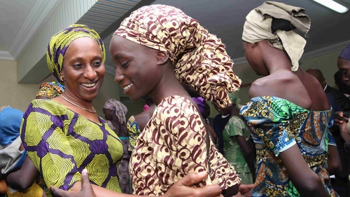 The wife of the Vice President of Nigeria, Oludolapo Osinbajo (left) consoling one of the released Chibok girls after their release