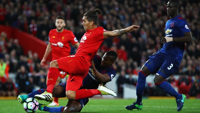Antonio Valencia tackles Roberto Firmino