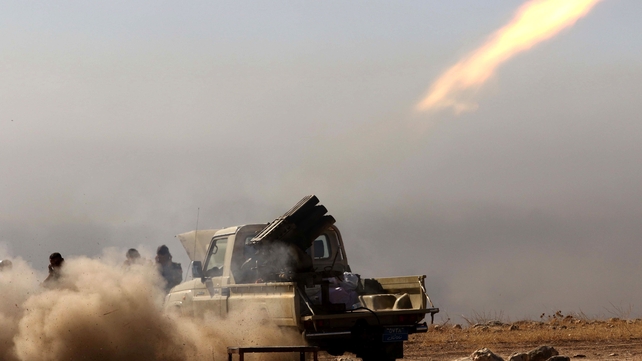 Iraqi Kurdish Peshmerga fighters fire a multiple rocket launcher east of Mosul