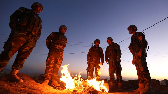 Iraqi Kurdish Peshmerga fighters gather on the top of Mount Zardak