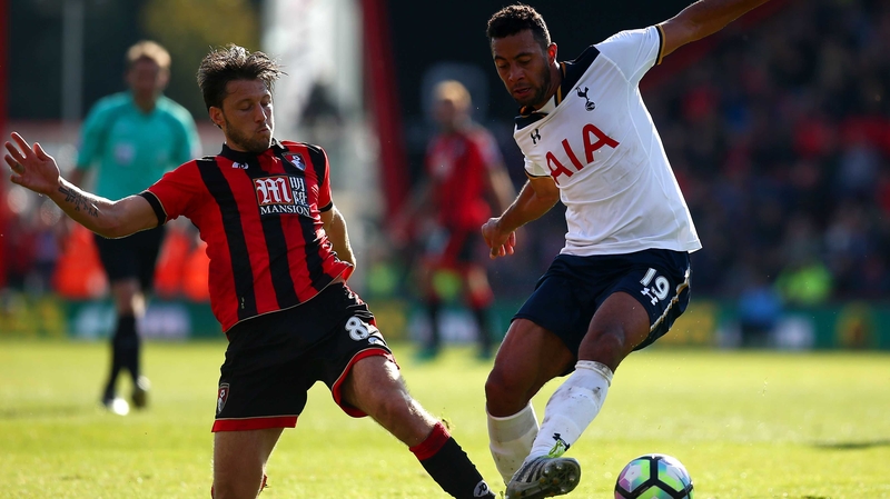 Harry Arter (L) challenges Mousa Dembele of Tottenham