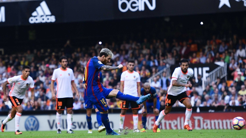 Lionel Messi slots home the winning penalty against Valencia
