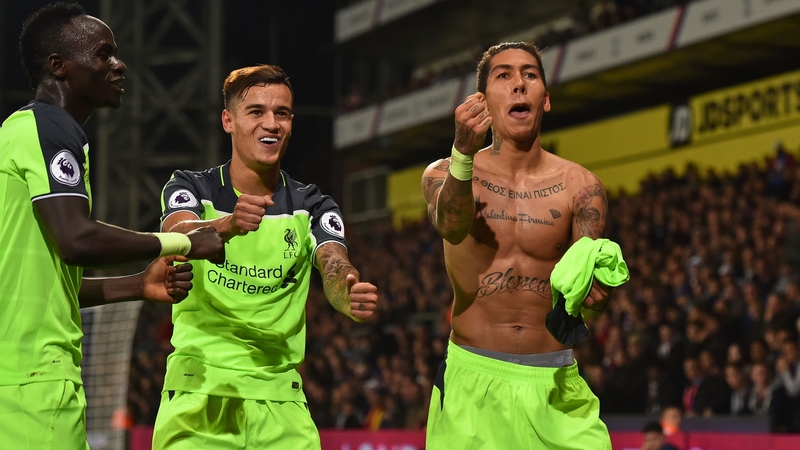 Roberto Firmino (r) celebrates Liverpool's fourth goal in south London