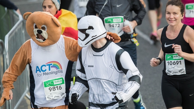A Stormtrooper and an Ewok support each other
