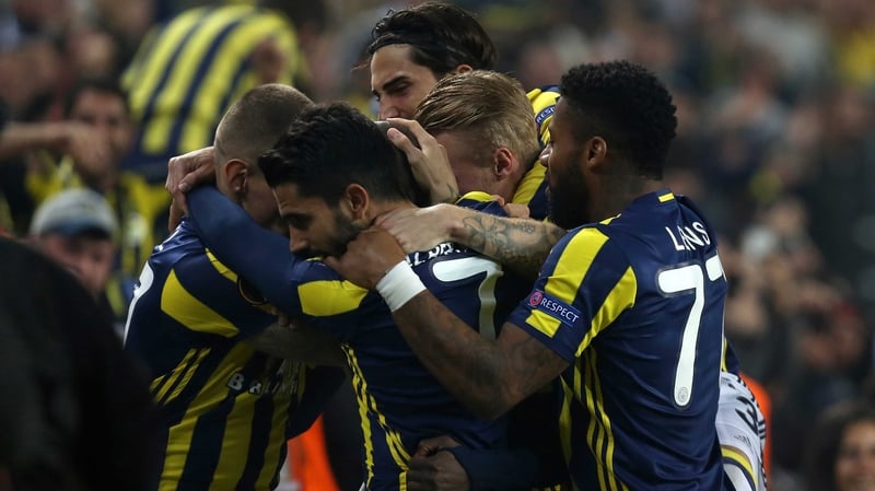 Fenerbahce's Moussa Sow (hidden) is mobbed by teammates after his opener