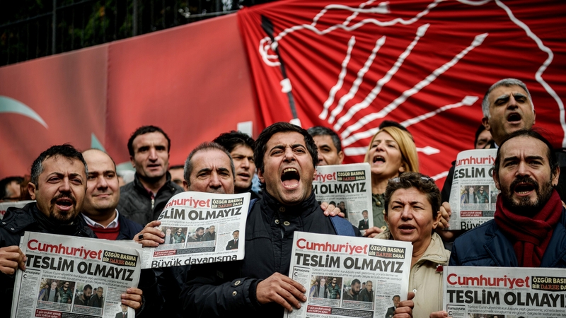 Protesters demonstrate after journalists from an opposition newspaper were detained
