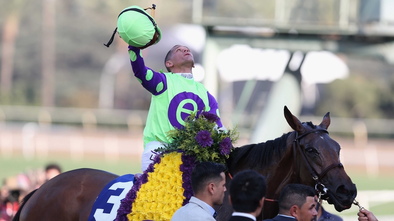 Jockey Javier Castellano aboard New Money Honey celebrates after winning in the Breeders' Cup Juvenile Fillies Turf