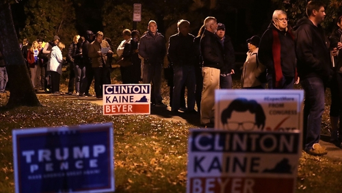 Voters wait in line for casting their ballots outside a polling place in Alexandria, Virginia