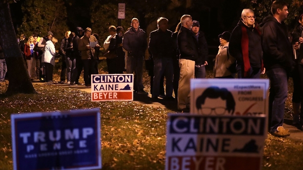 Voters wait in line for casting their ballots outside a polling place in Alexandria, Virginia