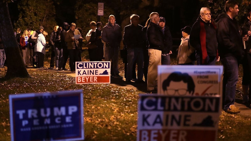 Voters wait in line for casting their ballots outside a polling place in Alexandria, Virginia
