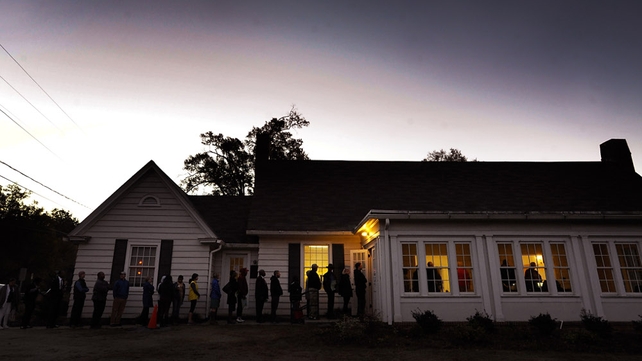 A queue forms outside a voting precinct before it opens in Durham, North Carolina