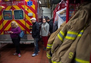 People wait to vote at a poll station inside a fire station in Arlington, Virginia