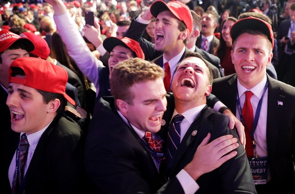 People cheer as voting results for Iowa were announced