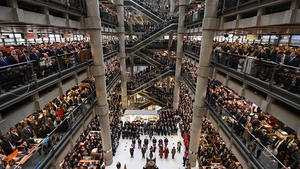 Workers and guests mark the two minute silence for Armistice Day in the Lloyd’s Building in London, England