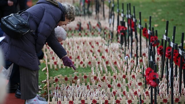 People look at Crosses of Remembrance as they pay their respects at Westminster Abbey in central London
