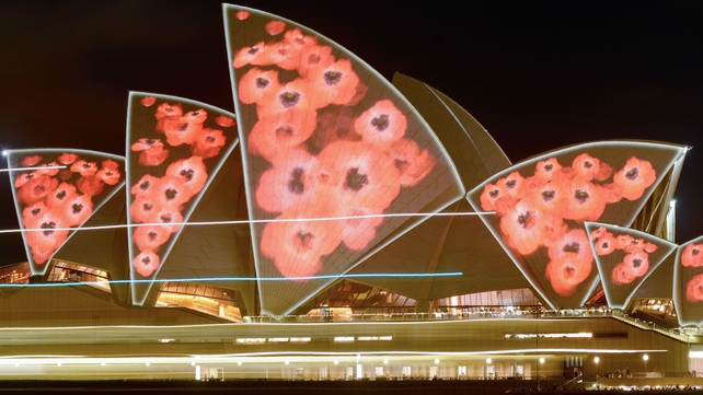 The roof, known as sails, of the Sydney Opera House is illuminated with a projection of poppies on Remembrance Day in Sydney, Australia