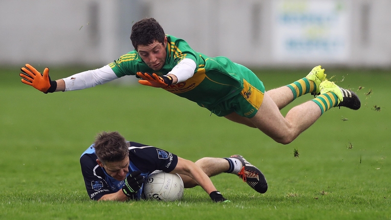 Paul McPadden of Rhode dives over Simonstown's Seamus Kenny