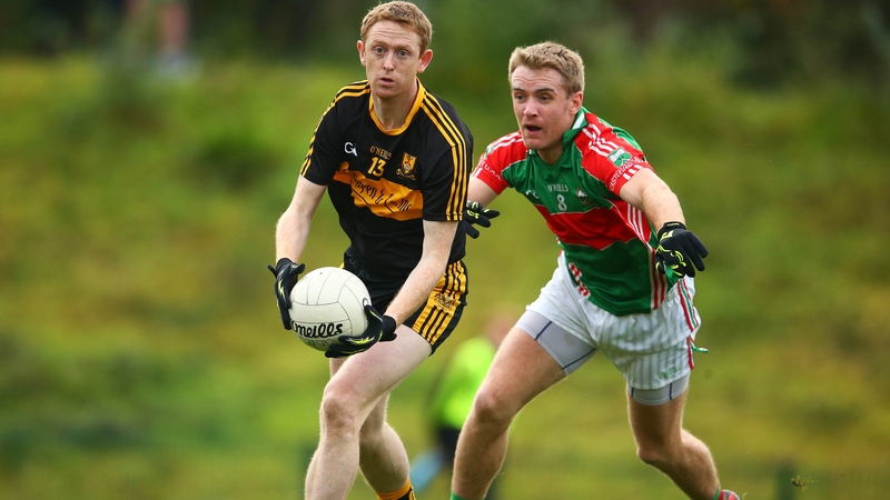 Colm Cooper under pressure from Noel McGrath