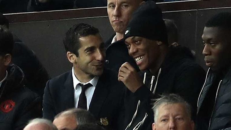 Henrikh Mkhitaryan (L) jokes with Anthony Martia in the stands
