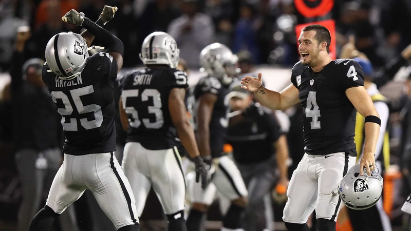 Derek Carr (R) celebrates with D.J. Hayden following the win