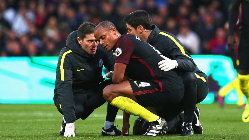 Vincent Kompany receives treatment following a clash with keeper Claudio Bravo