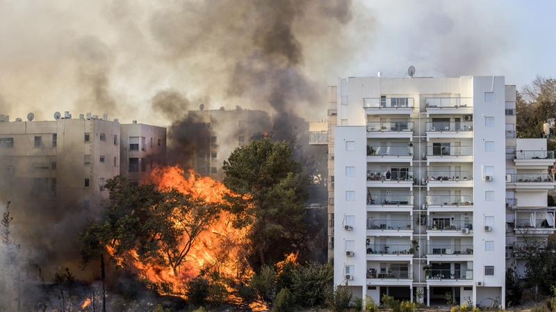 Flames are seen close to tower blocks in Haifa