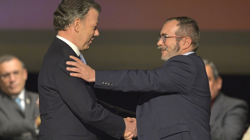 Juan Manuel Santos and Rodrigo 'Timochenko' Londono inked the pact with a pen made from a bullet