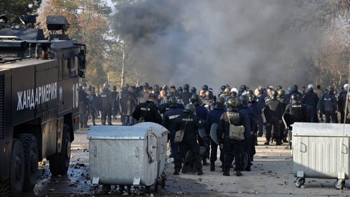 Angry migrants set car tyres on fire and threw stones at around 250 police officers