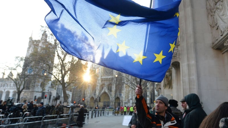 A man waves a flag outside the Supreme Court in London