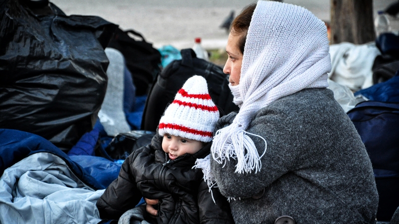 A woman refugee holds her baby at the Souda refugee camp on the Greek island of Chios