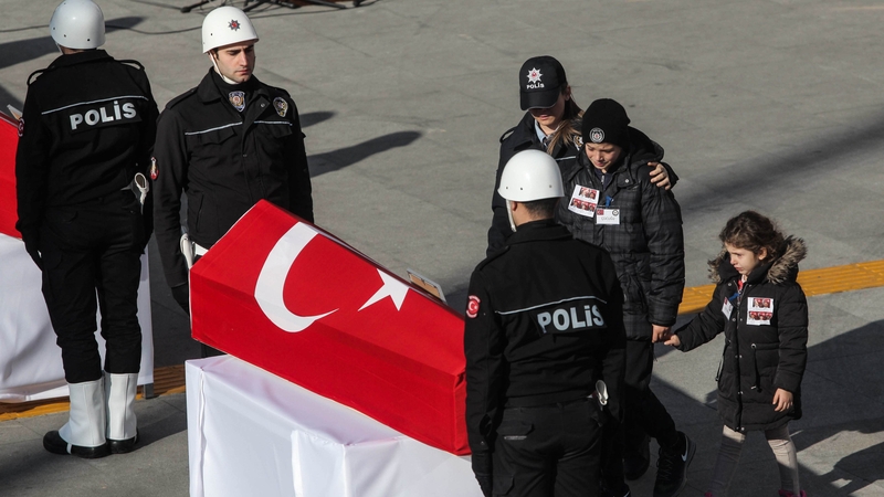 Relatives mourn one of the police officers killed in the attack