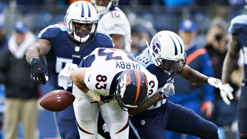 AJ Derby (No 83) of the Denver Broncos is hit after catching a pass by Chris Harris Jr of the Tennessee Titans